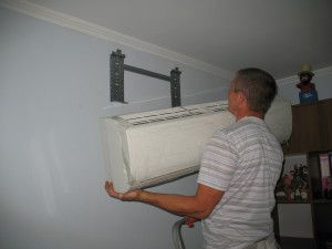 Mounting the air conditioner on the brackets